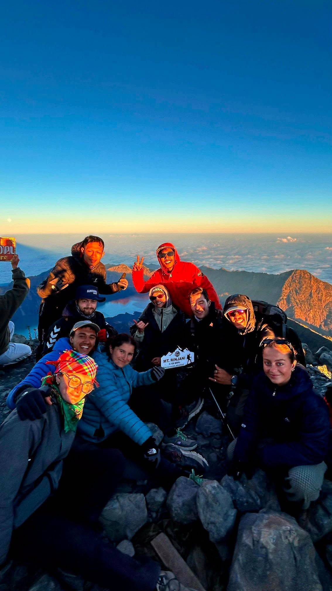 Trekkers celebrating at the summit of Mount Rinjani